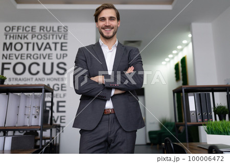 portrait of a successful male lawyer standing in an office building with arms crossed portrait of a successful male lawyer standing in an office building with arms crossed 100006472