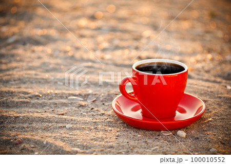 Coffee cup on sand Coffee cup on sand 100010552