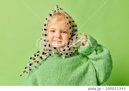 Happy smiling cute kid, little girl in fashionable look clothes and sunglasses posing over light green background. Spring fashion collection, happiness, ad concept Happy smiling cute kid, little girl in fashionable look clothes and sunglasses posing over light green background. Spring fashion collection, happiness, ad concept 100011343