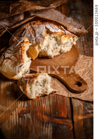 Broken fresh bread 100013669