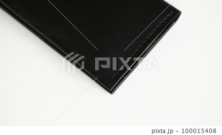 Details of black genuine leather wallet on a white background. Men's accessories. Details of black genuine leather wallet on a white background. Men's accessories. 100015408