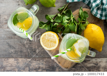Lemonade drink in a jar glass on wooden table 100017433