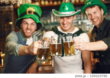 Men celebrate St. Patrick's Day at bar with a mug of beer Men celebrate St. Patrick's Day at bar with a mug of beer 100020786