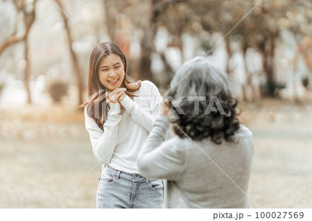 Portrait of an adult daughter with her elderly mother and take a photo and happy moment 100027569
