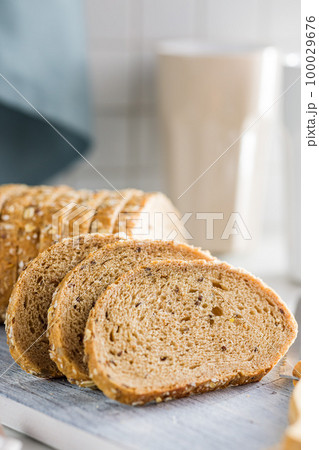 Sliced whole grain bread. Tasty wholegrain pastry with seeds Sliced whole grain bread. Tasty wholegrain pastry with seeds 100029676