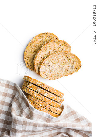 Sliced whole grain bread. Tasty wholegrain pastry with seeds isolated on white background. Sliced whole grain bread. Tasty wholegrain pastry with seeds isolated on white background. 100029713