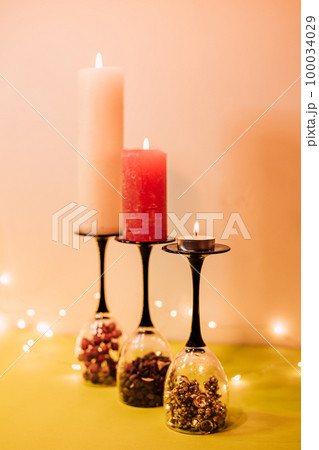 Composition of glasses, candles and decorative elements. New Year's mood 100034029
