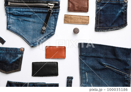 Composition with garment accessories and cutting details for jeans isolated on white, top view Composition with garment accessories and cutting details for jeans isolated on white, top view 100035186