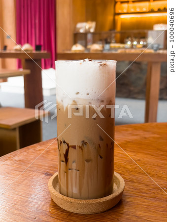 Iced coffee mocha on wooden table in coffee shop Iced coffee mocha on wooden table in coffee shop 100040696