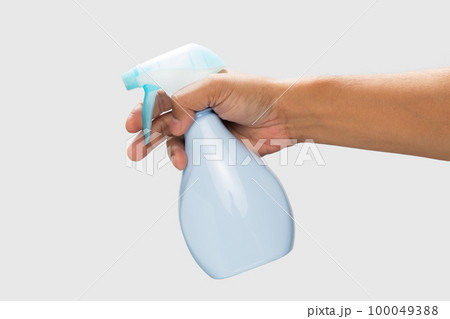 Hand holding a disinfectant spray 100049388