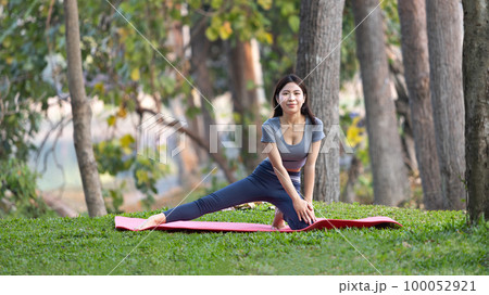Asian woman doing yoga in nature in the forest, Meditation and breathing exercises, Treat ADHD and train your mind to be calm, Healthy exercise, Mindfulness, Homeopathy, Park yoga. Asian woman doing yoga in nature in the forest, Meditation and breathing exercises, Treat ADHD and train your mind to be calm, Healthy exercise, Mindfulness, Homeopathy, Park yoga. 100052921