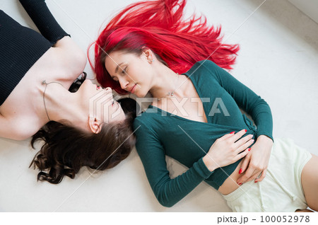Top view of caucasian women lying and kissing. Top view of caucasian women lying and kissing. 100052978