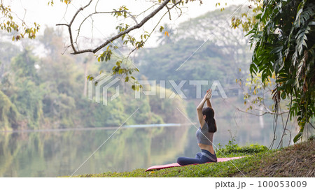 Asian woman doing yoga in nature in the forest, Meditation and breathing exercises, Treat ADHD and train your mind to be calm, Healthy exercise, Mindfulness, Homeopathy, Park yoga. Asian woman doing yoga in nature in the forest, Meditation and breathing exercises, Treat ADHD and train your mind to be calm, Healthy exercise, Mindfulness, Homeopathy, Park yoga. 100053009