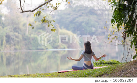 Asian woman doing yoga in nature in the forest, Meditation and breathing exercises, Treat ADHD and train your mind to be calm, Healthy exercise, Mindfulness, Homeopathy, Park yoga. Asian woman doing yoga in nature in the forest, Meditation and breathing exercises, Treat ADHD and train your mind to be calm, Healthy exercise, Mindfulness, Homeopathy, Park yoga. 100053204