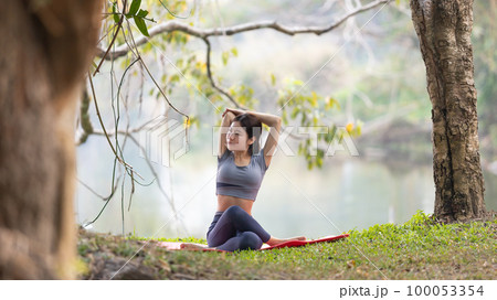 Asian woman doing yoga in nature in the forest, Meditation and breathing exercises, Treat ADHD and train your mind to be calm, Healthy exercise, Mindfulness, Homeopathy, Park yoga. Asian woman doing yoga in nature in the forest, Meditation and breathing exercises, Treat ADHD and train your mind to be calm, Healthy exercise, Mindfulness, Homeopathy, Park yoga. 100053354