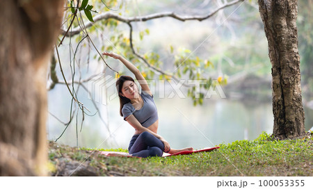 Asian woman doing yoga in nature in the forest, Meditation and breathing exercises, Treat ADHD and train your mind to be calm, Healthy exercise, Mindfulness, Homeopathy, Park yoga. Asian woman doing yoga in nature in the forest, Meditation and breathing exercises, Treat ADHD and train your mind to be calm, Healthy exercise, Mindfulness, Homeopathy, Park yoga. 100053355