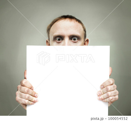 Surprised man holding blank sign paper 100054552