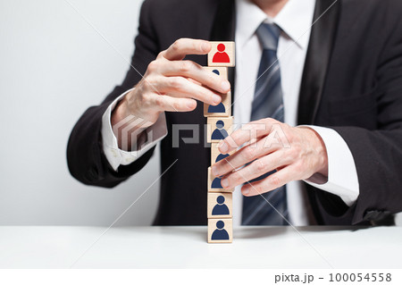 Wooden blocks with people icons and businessman hands, team, carieer, teamwork business concept 100054558