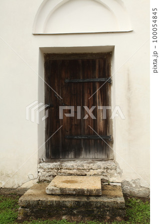 Old vintage door, enter to white construction 100054845