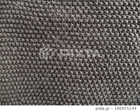 Gray knitted texture woolen fabric Textile knit pattern wallpaper background surface design. Handmade shop cozy backdrop Gray knitted texture woolen fabric Textile knit pattern wallpaper background surface design. Handmade shop cozy backdrop 100055234