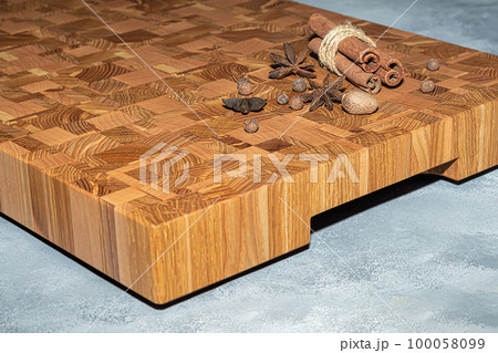 Wooden board for cutting handmade products with chopped vegetables. On a light background. Wooden board for cutting handmade products with chopped vegetables. On a light background. 100058099