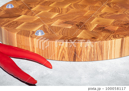 Wooden board for cutting handmade products with chopped vegetables. On a light background. Wooden board for cutting handmade products with chopped vegetables. On a light background. 100058117