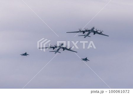 Russia. Kronstadt. July 31, 2022. A flight of Tu-142M3 and MIG-29KUB aircraft at the naval parade. Russia. Kronstadt. July 31, 2022. A flight of Tu-142M3 and MIG-29KUB aircraft at the naval parade. 100061072
