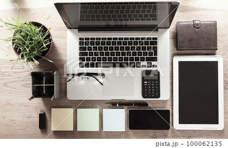 top view. office supplies and stationery items on a wooden table 100062135