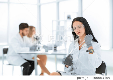 close up.woman scientist takes a sample of the liquid . 100063109
