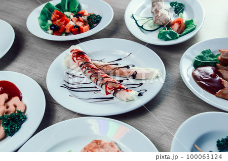 tubes with cream filling and other dishes on the table 100063124