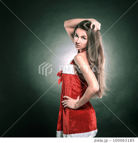 rear view.stylish young woman in costume of Santa Claus looking 100063185