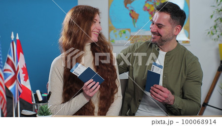 A happy couple shows their tickets and passports, expressing great joy because they got the chance to spend their summer vacation abroad. Travelling concept. A happy couple shows their tickets and passports, expressing great joy because they got the chance to spend their summer vacation abroad. Travelling concept. 100068914
