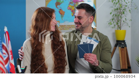 A happy couple shows their tickets and passports, expressing great joy because they got the chance to spend their summer vacation abroad. Travelling concept. A happy couple shows their tickets and passports, expressing great joy because they got the chance to spend their summer vacation abroad. Travelling concept. 100068934