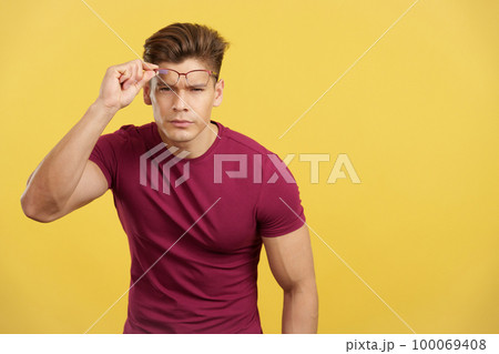 Strong man taking off her eyeglasses to see ahead Strong man taking off her eyeglasses to see ahead 100069408