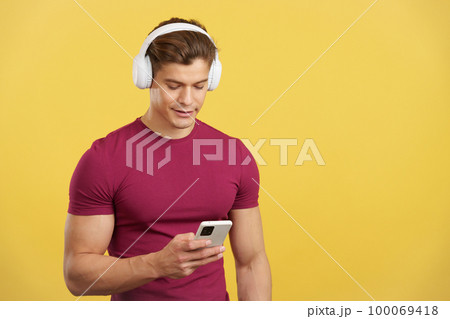 Relaxed man listening to music with the mobile and headphones Relaxed man listening to music with the mobile and headphones 100069418