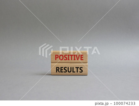 Positive results symbol. Concept words 'Positive results' on wooden blocks. Beautiful grey background. Business and Positive results concept. Copy space. 100074233