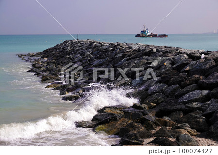 A breakwater from the embankment of huge stones to protect the beach from the sea wave A breakwater from the embankment of huge stones to protect the beach from the sea wave 100074827