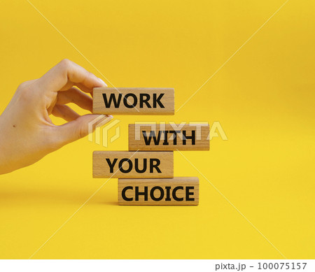 Work with your choice symbol. Wooden blocks with words Work with your choice. Beautiful yellow background. Businessman hand. We Work with your choice concept. Copy space. 100075157