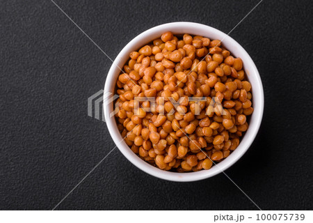 Delicious healthy canned lentils in a ceramic ribbed white bowl 100075739