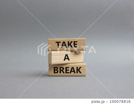 Take a break symbol. Concept words 'Take a break' on wooden blocks. Beautiful grey background. Business and Take a break concept. Copy space. Take a break symbol. Concept words 'Take a break' on wooden blocks. Beautiful grey background. Business and Take a break concept. Copy space. 100078816