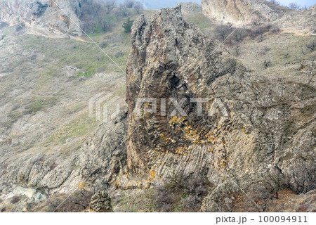 Devil's fireplace rock and bizarre rocks in Dead city. Khoba-Tele Ridge of Karadag Reserve in spring. Crimea 100094911