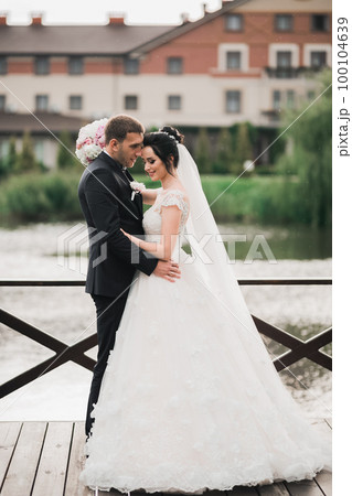 Wedding couple on the nature is hugging each other. Beautiful model girl in white dress. Man in suit Wedding couple on the nature is hugging each other. Beautiful model girl in white dress. Man in suit 100104639