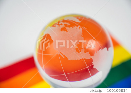 Crystal globe on a rainbow flag. LGBT community. 100106834
