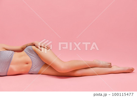 Beautiful slender female legs over pink background. Concept of beauty, body and skin care, healthy lifestyle, fashion, depilation, cosmetics, spa. Beautiful slender female legs over pink background. Concept of beauty, body and skin care, healthy lifestyle, fashion, depilation, cosmetics, spa. 100115477