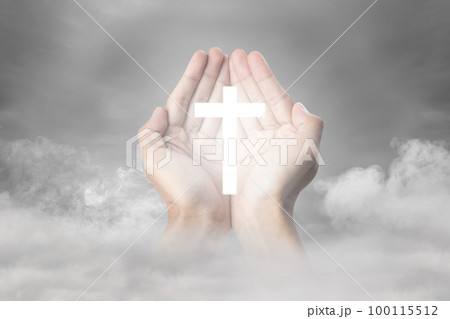 A human hand showing a Christian cross A human hand showing a Christian cross 100115512