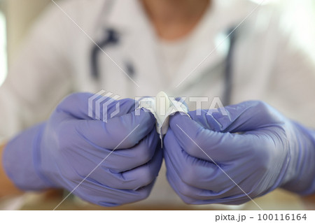 Gynecologist shows suppositories for anal or vaginal use close up. 100116164