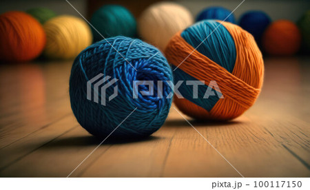 Colored thread for knitting on a wooden floor. Space for copy. Knitting concept 100117150