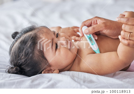 Thermometer, sick and baby on bad with fever, cold and flu symptoms in bedroom with tool to check temperature. Family, child care and parent with sad newborn kid testing for ill, virus or infection Thermometer, sick and baby on bad with fever, cold and flu symptoms in bedroom with tool to check temperature. Family, child care and parent with sad newborn kid testing for ill, virus or infection 100118913