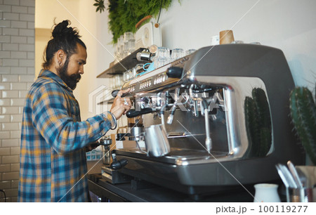 Cafe, startup and service with a man barista behind the counter to prepare a drink. Coffee shop, kitchen and waiter with a male working in a restaurant as an entrepreneur or small business owner 100119277