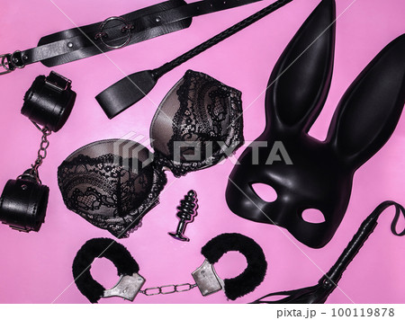 set of intimate erotic sex toys for adults for BDSM sex with submission and domination. Handcuffs, flogger whip, mask and bra set of intimate erotic sex toys for adults for BDSM sex with submission and domination. Handcuffs, flogger whip, mask and bra 100119878